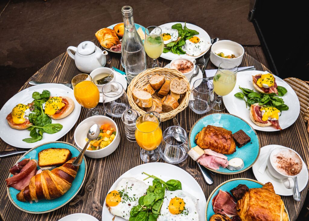 pexels-photo-9068414-9068414 Savor the flavors of a classic Parisian brunch featuring croissants, eggs Benedict, and fresh juice on a wooden table.